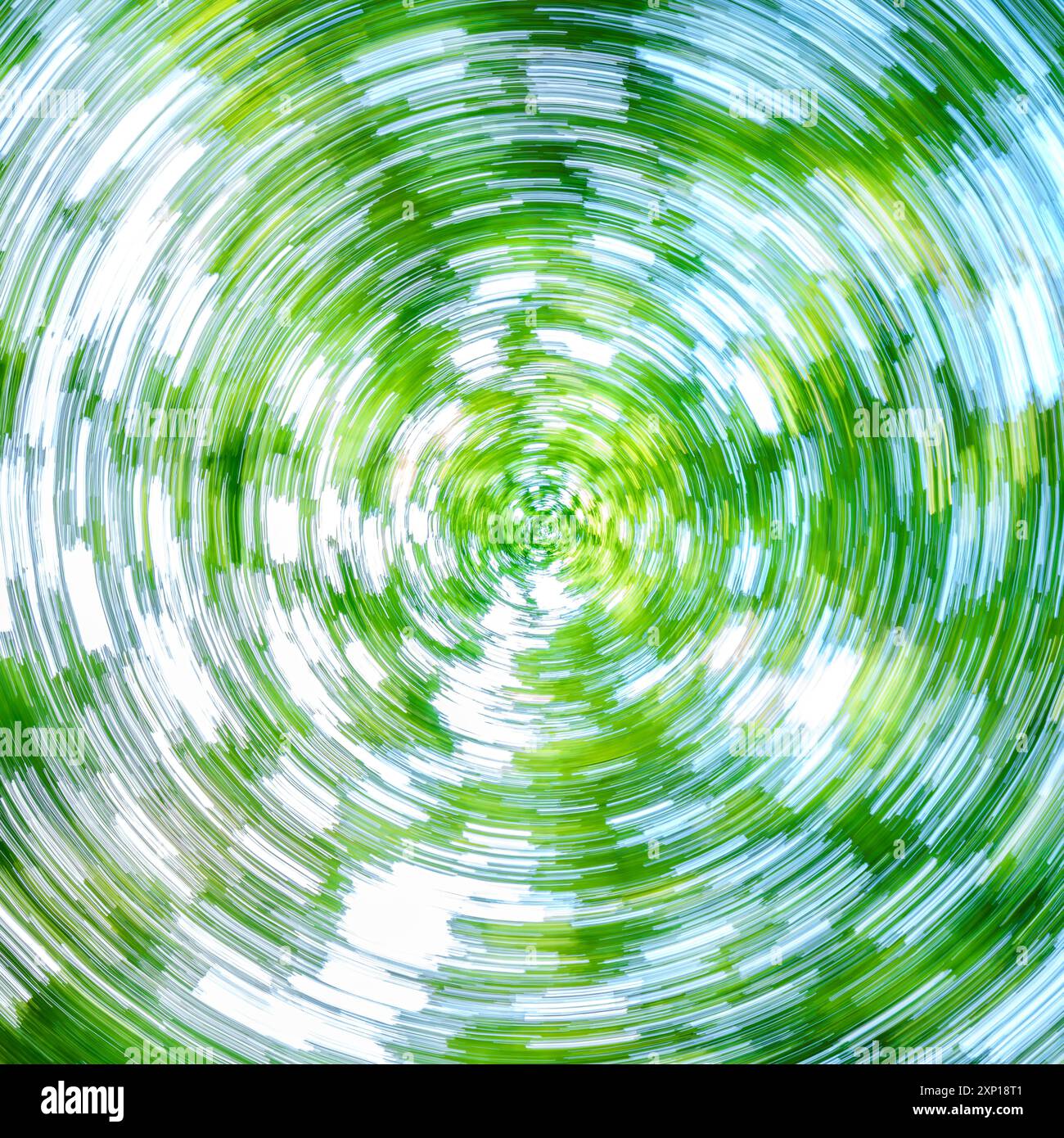 Un'immagine astratta accattivante e incantevole che mostra vibranti spirali di verde lussureggiante e blu intenso Foto Stock