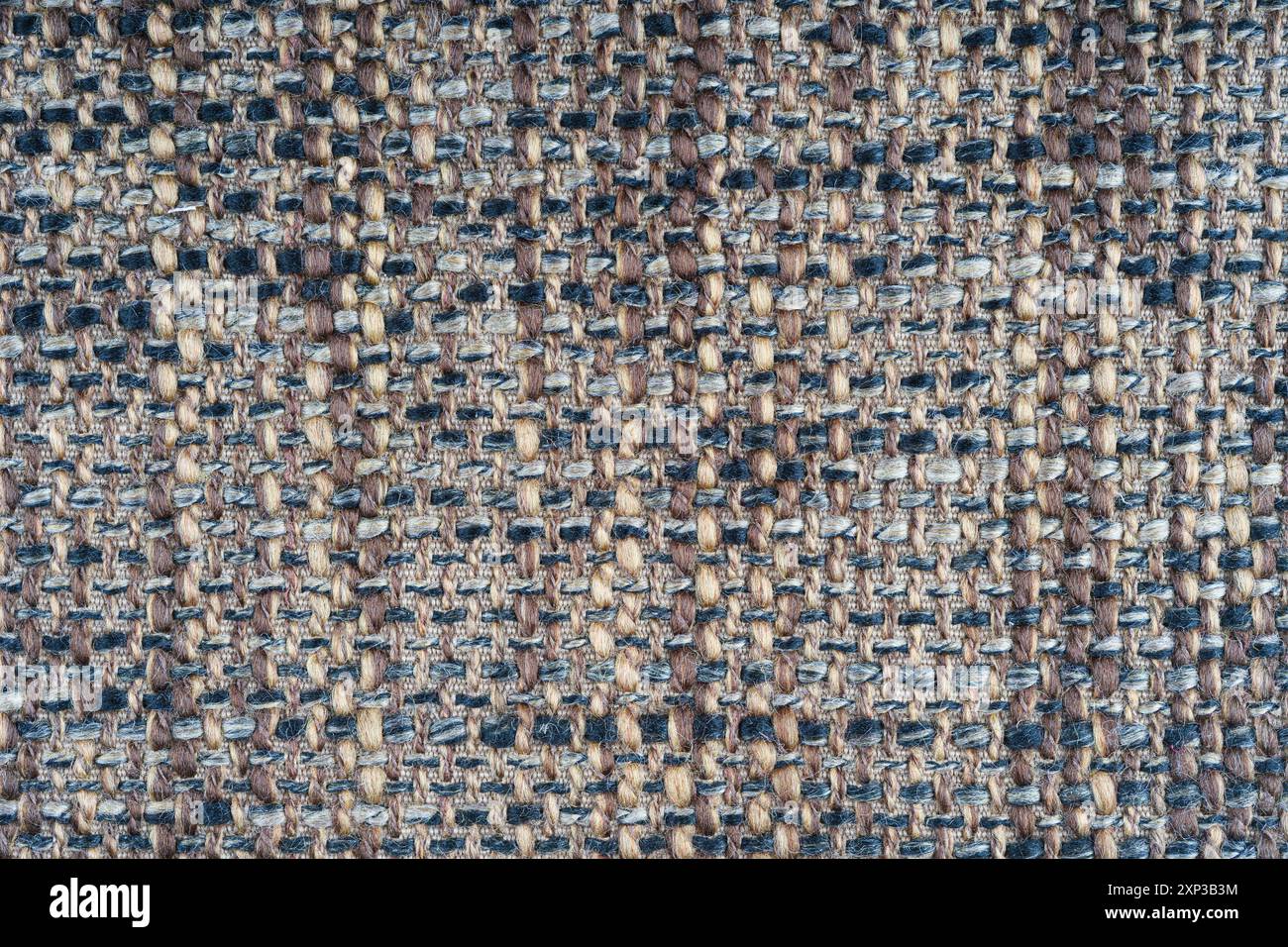 Trama del tessuto jacquard marrone con trama ruvida macro, primo piano. Panno melange di colore misto. Materiale per tessuti per la casa, tappezzeria e decorazione di tende, Foto Stock