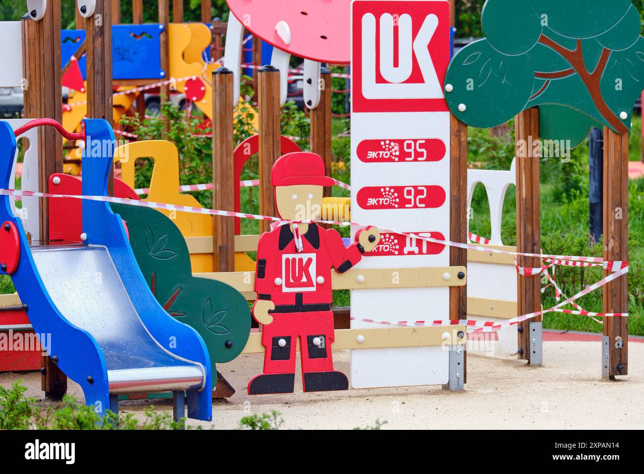 Parco giochi per bambini con colorate strutture per giochi e distributore di benzina. Decorazioni a tema Lukoil con elementi in legno e scivolo. Attività all'aperto e PL Foto Stock