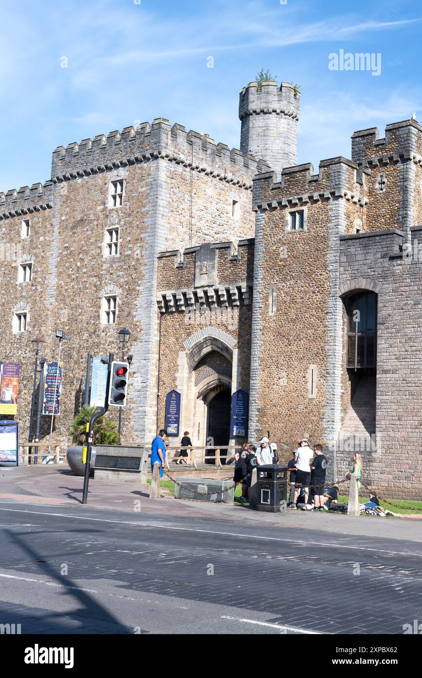 I turisti si rilassano fuori dal cancello principale del castello di Cardiff nel Regno Unito. Foto Stock