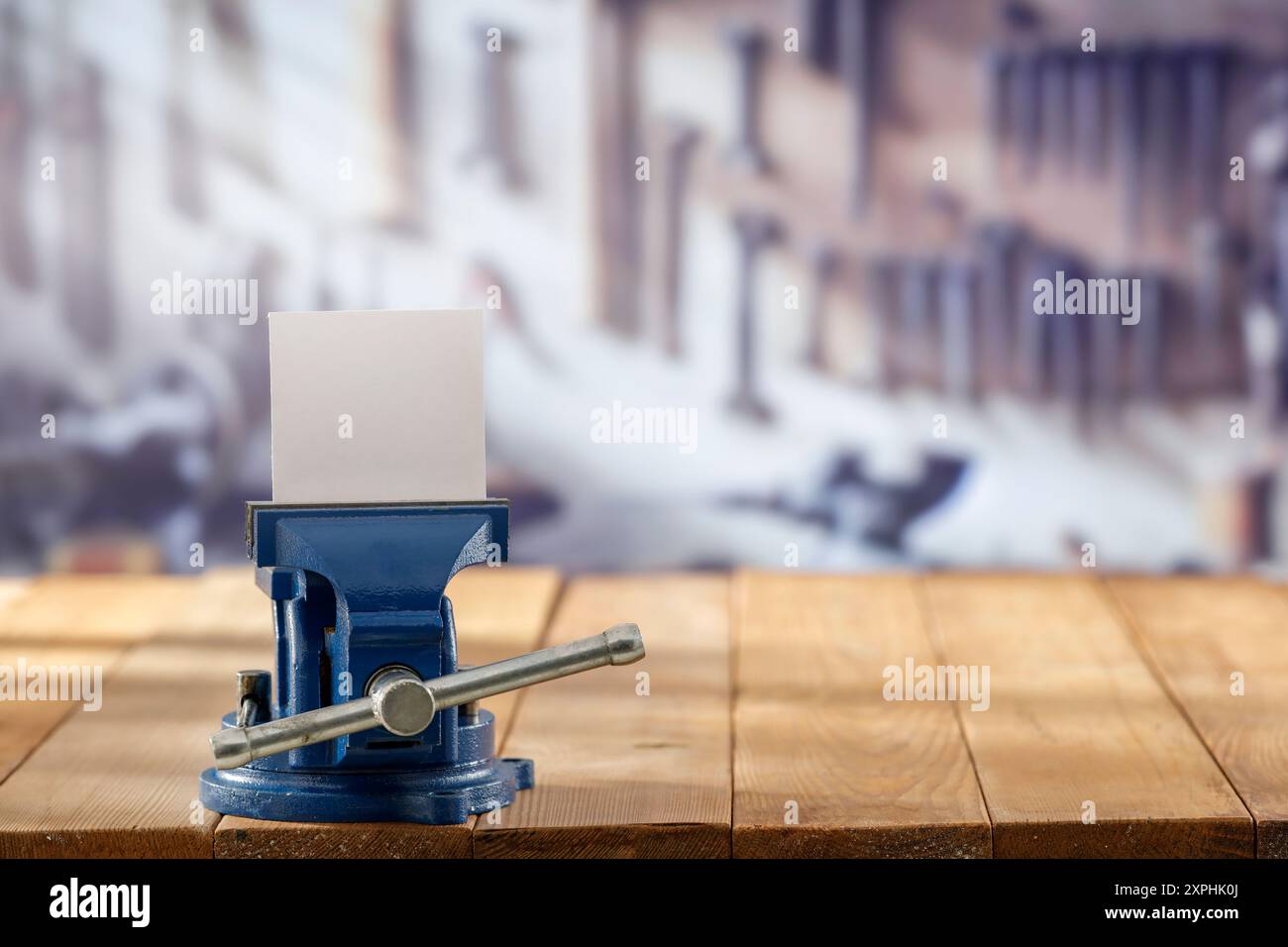 Utensili da falegname e morsa per fabbro su tavolo in legno su sfondo sfocato dell'officina, montaggio su espositore Foto Stock