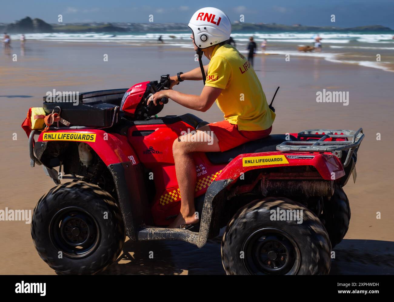 RNLI in servizio a Watergate Bay, con un attento controllo per eventuali incidenti e pronto per i salvataggi rapidi. Siate orgogliosi di questi volontari qualificati per il loro lavoro Foto Stock