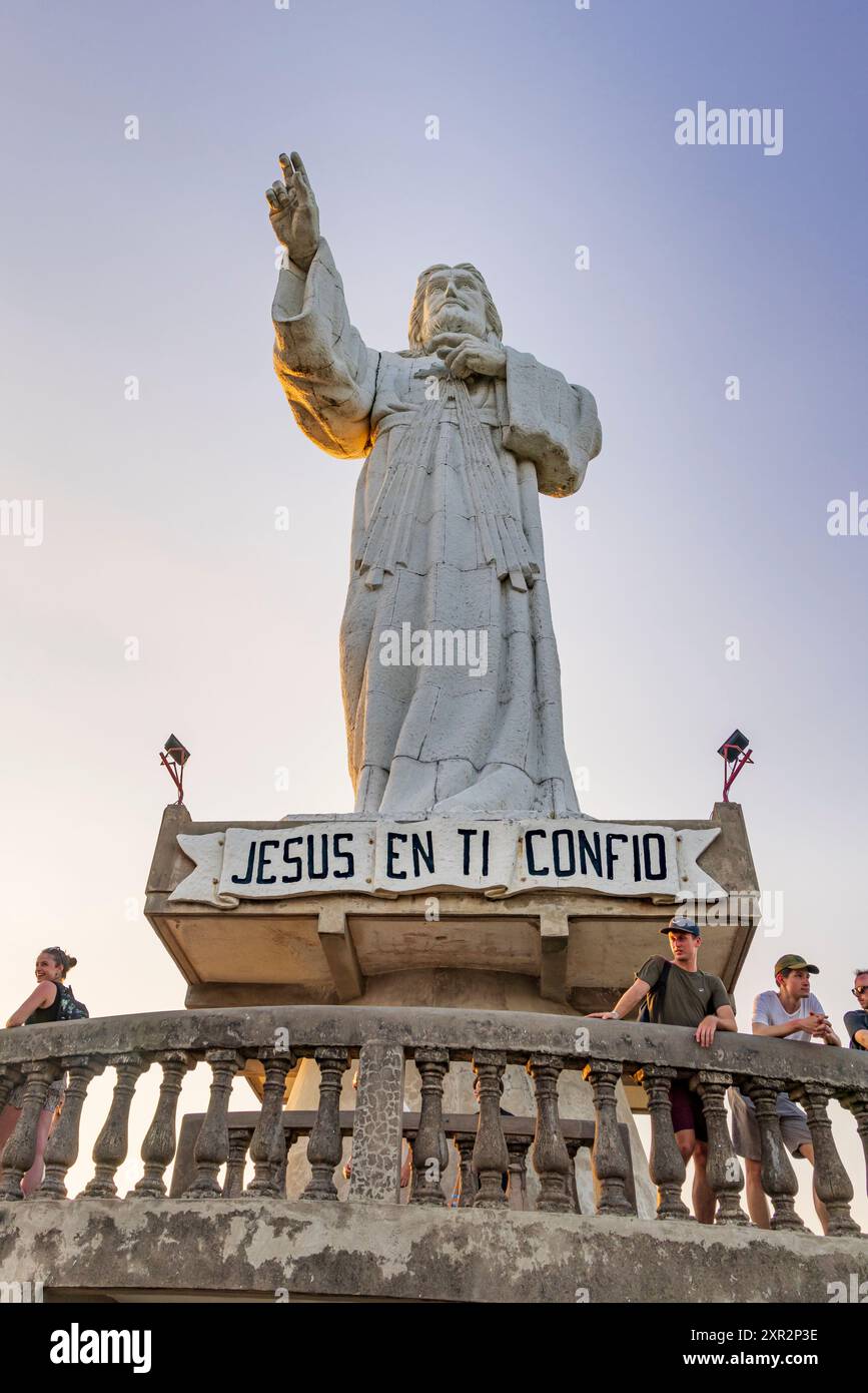 San Juan del Sur, Nicaragua - 23 marzo 2024: Imponente statua contemporanea del Cristo della Misericordia in piedi su una scogliera sopra la baia di San Juan del Sur. Foto Stock