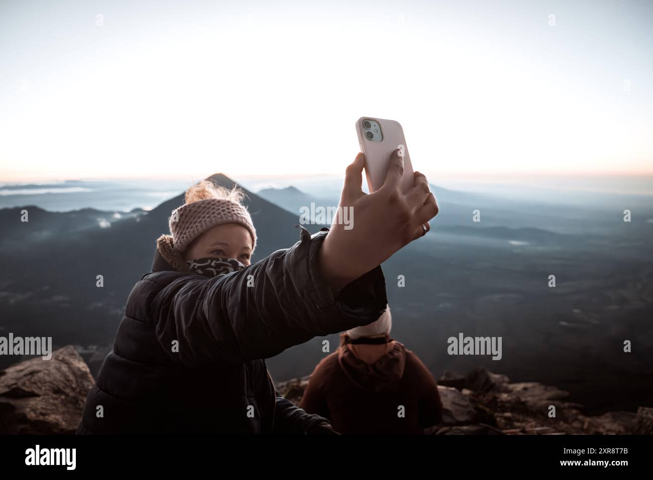 Selfie panoramico all'alba: La donna che viaggia cattura la vista maestosa dell'alba Foto Stock