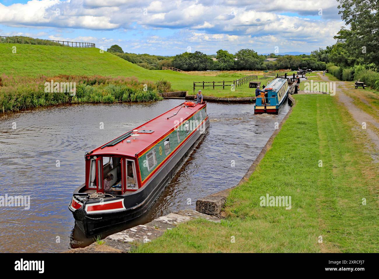 Persone su barche strette del canale, che passano l'un l'altro alle chiuse di Hurleston sul canale Llangollen a Hurleston Cheshire Inghilterra Regno Unito Foto Stock