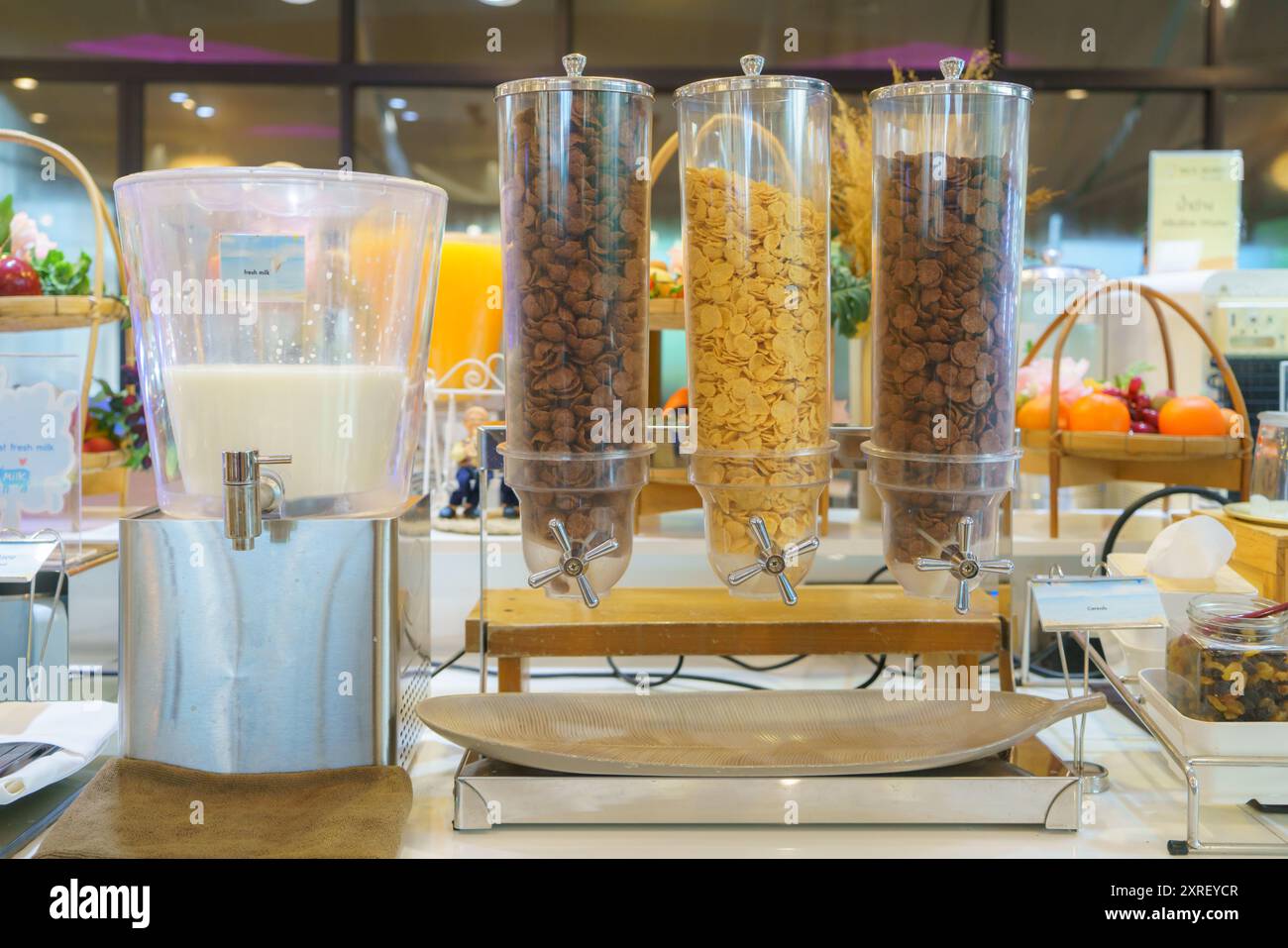 La colazione prevede un distributore di cereali con tre vani pieni di diversi tipi di cereali. Foto Stock