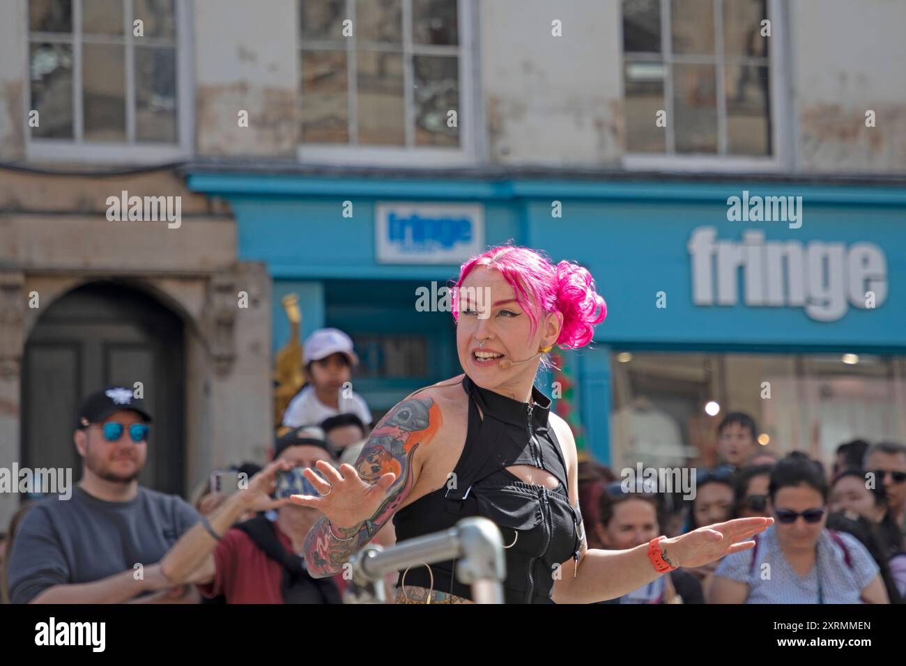 Edinburgh Festival Fringe, centro città, Scozia, Regno Unito. 11 agosto 2024 domenica di sole per il secondo fine settimana del Fringe nella capitale scozzese. Affollato con i visitatori per assistere agli spettacoli di strada e rilassarsi al sole. Nella foto: Missy Impossible Street performer nel Royal Mile. Credito: Arch White/alamy notizie dal vivo. Foto Stock