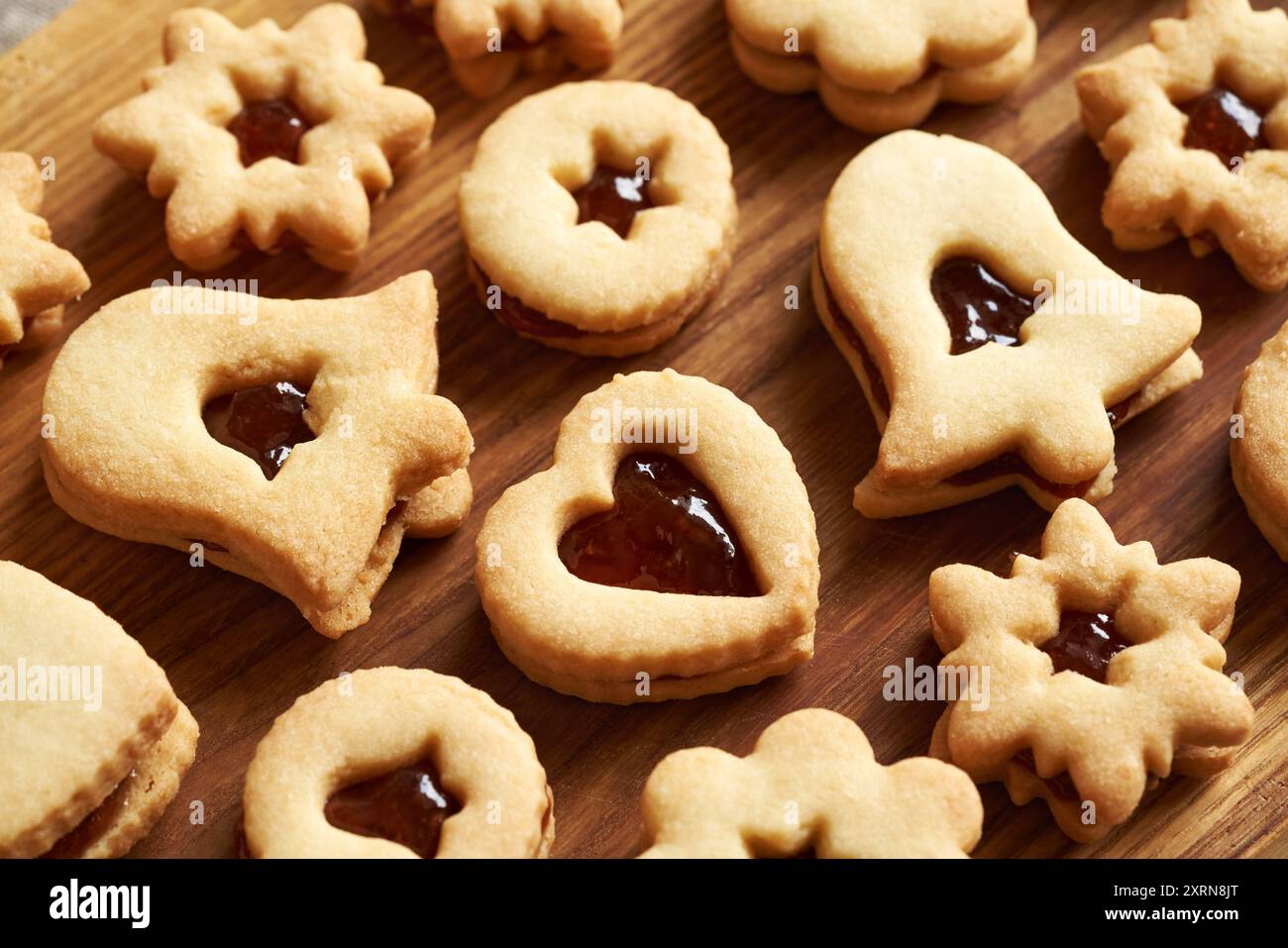 Biscotti di Natale Linzer a forma di cuore, stella e campana ripieni di marmellata rossa Foto Stock