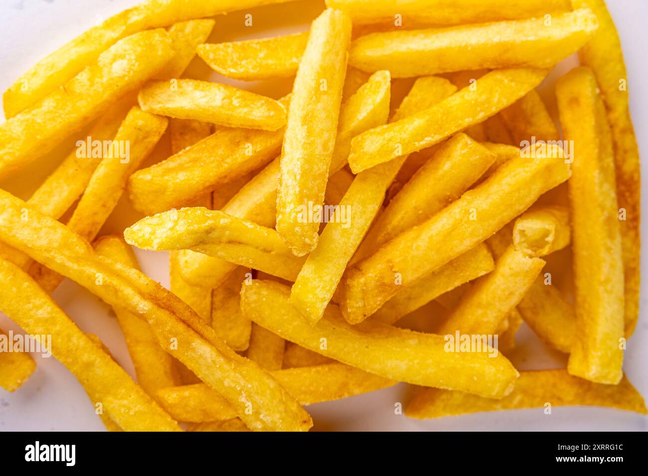 Primo piano di patatine fritte croccanti - Un ipnotico primo piano di patatine fritte dorate croccanti, che mettono in risalto la consistenza perfetta di ogni frittura e il fascino irresistibile. Foto Stock