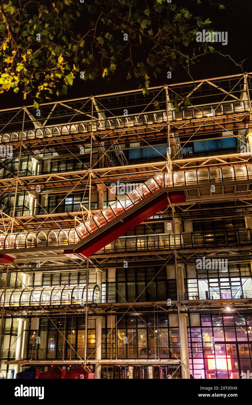 Vista esterna notturna del Centro Pompidou, con lo scheletro esposto di tubi dai colori vivaci per sistemi meccanici, Parigi, Francia Foto Stock