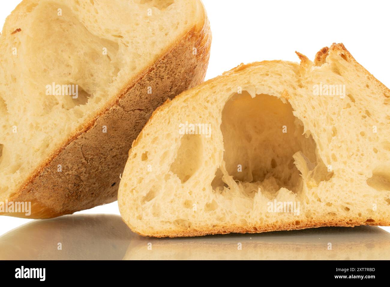 Una pagnotta di grano tagliata a metà, macro, isolata su sfondo bianco. Foto Stock
