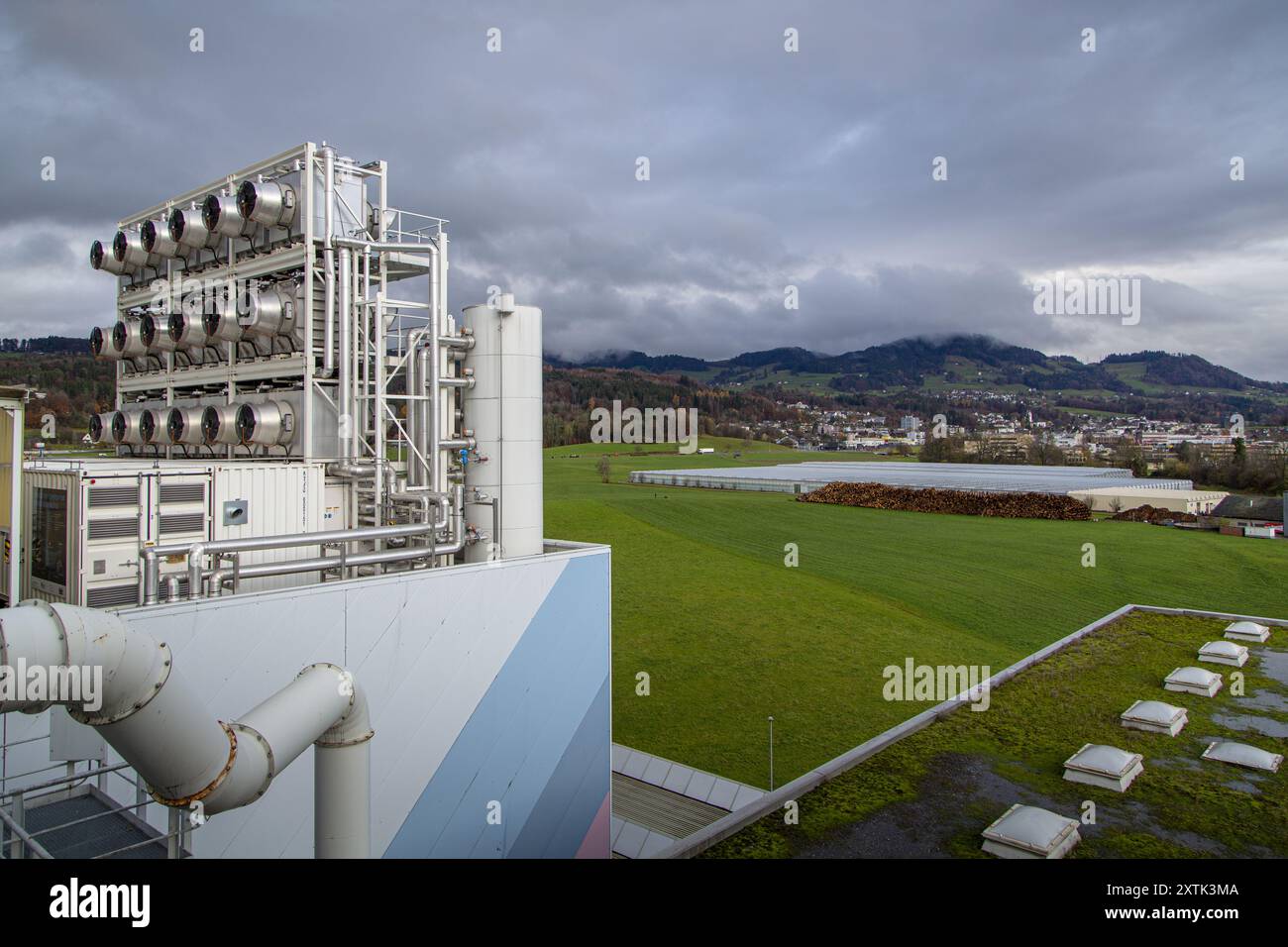 La società svizzera Climeworks eseguono 30 DAC - dirigere aria Capture - ventole sul tetto di questo inceneritore di rifiuti a Hinwil al di fuori di Zurigo. Fondata nel 2009 da Christoph Gebald e Jan Wurzbacher, la società ha commercializzato il carbonio modulari unità di cattura, ciascuno dei quali è in grado di aspirare fino a 135 kg di CO2 nell'aria quotidianamente. Il processo è energia esigente, e le unità in Hilwil utilizzano energia in eccesso dall'inceneritore di eseguire i collettori. A sua volta la CO2 captato è utilizzato presso il vicino serra commerciale (in background) per aumentare la resa del prodotto e anche delivere Foto Stock