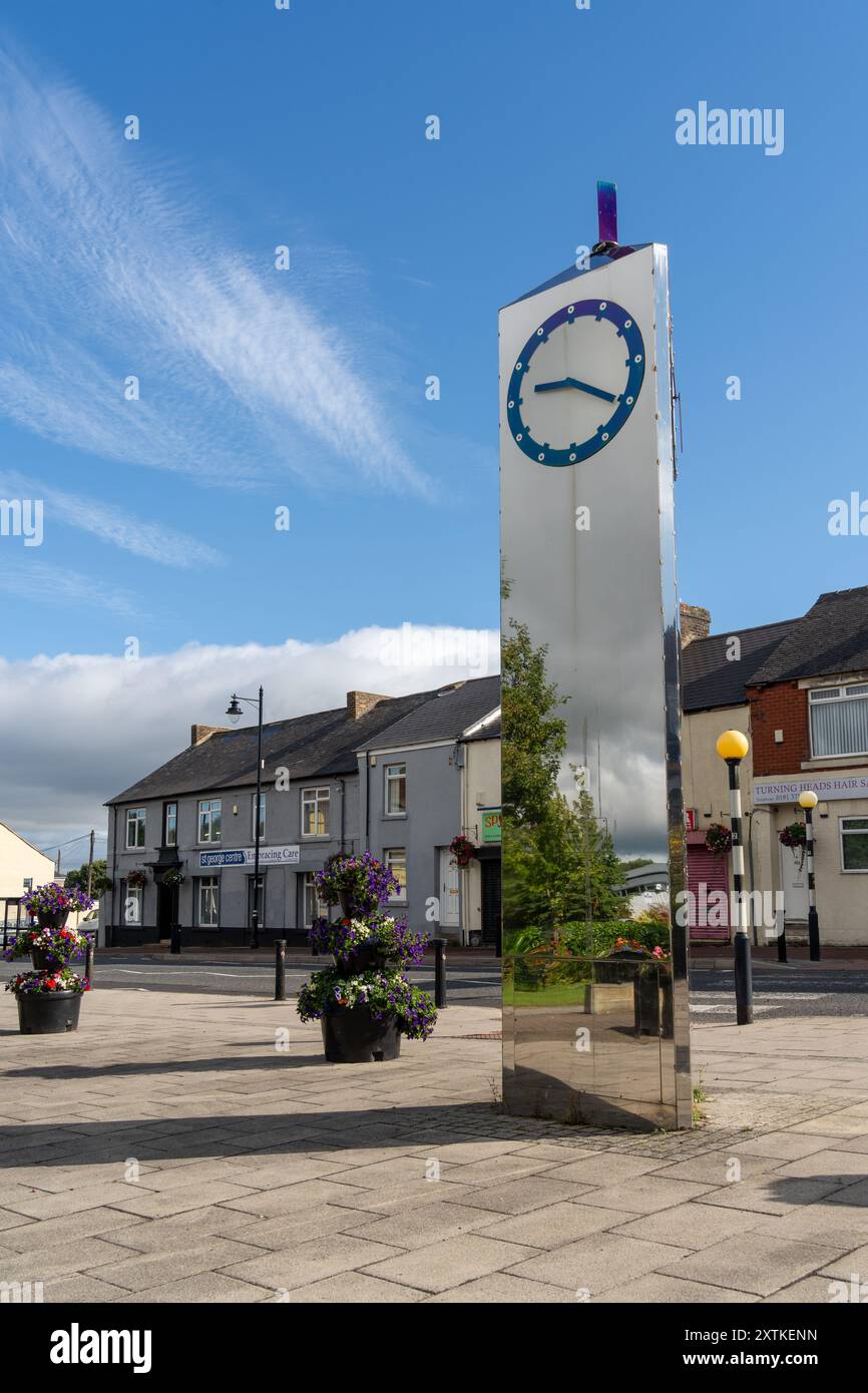 Sacriston, Contea di Durham, Regno Unito. La piazza e l'orologio della città - The Pulse di Diane Maclean, su Front Street, che commemora il minatore della città Foto Stock