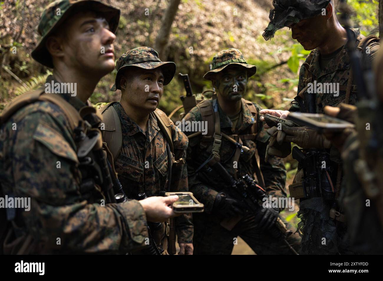 17 luglio 2024 - Camp Hansen, Okinawa, Giappone - Marines USA con 5th Air Naval Gunfire Liaison Company, III Marine Expeditionary Force Information Group, ricevono le coordinate per un nuovo checkpoint durante l'esercitazione di certificazione 24,3 a Camp Hansen, Okinawa, Giappone, 17 luglio 2024. CERTEX 24,3 è un esercizio di formazione progettato per valutare, valutare e certificare la capacità della 5a ANGLICO di coordinare incendi ed effetti, integrarsi con le forze alleate e dei partner e operare in modo indipendente in ambienti dinamici e difficili. (Immagine di credito: © Bridgette Rodriguez/U.S. Marines/ZUMA Press Wire) USO EDITORIALE ONL Foto Stock