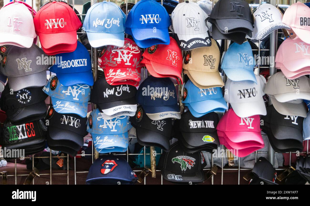Molti berretti da baseball sulla cremagliera di un mercante di strada a Manhattan, New York Foto Stock