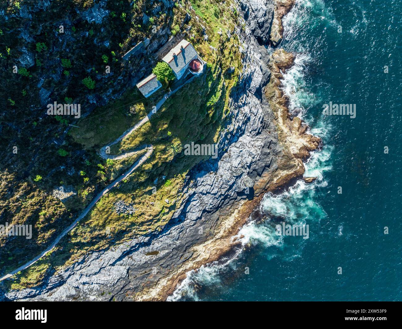 Veduta aerea del faro Hendanes Fyr, faro situato su una ripida scogliera, costa norvegese a ovest di Maloy, Vestland, Norvegia Foto Stock