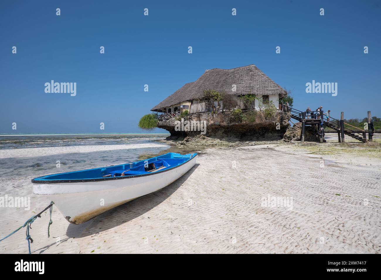 Il Rock Restaurant con la bassa marea, si erge sul suo isolotto di marea al largo di Pingwe Beach, Zanzibar, un'icona architettonica unica nell'Oceano Indiano. Foto Stock