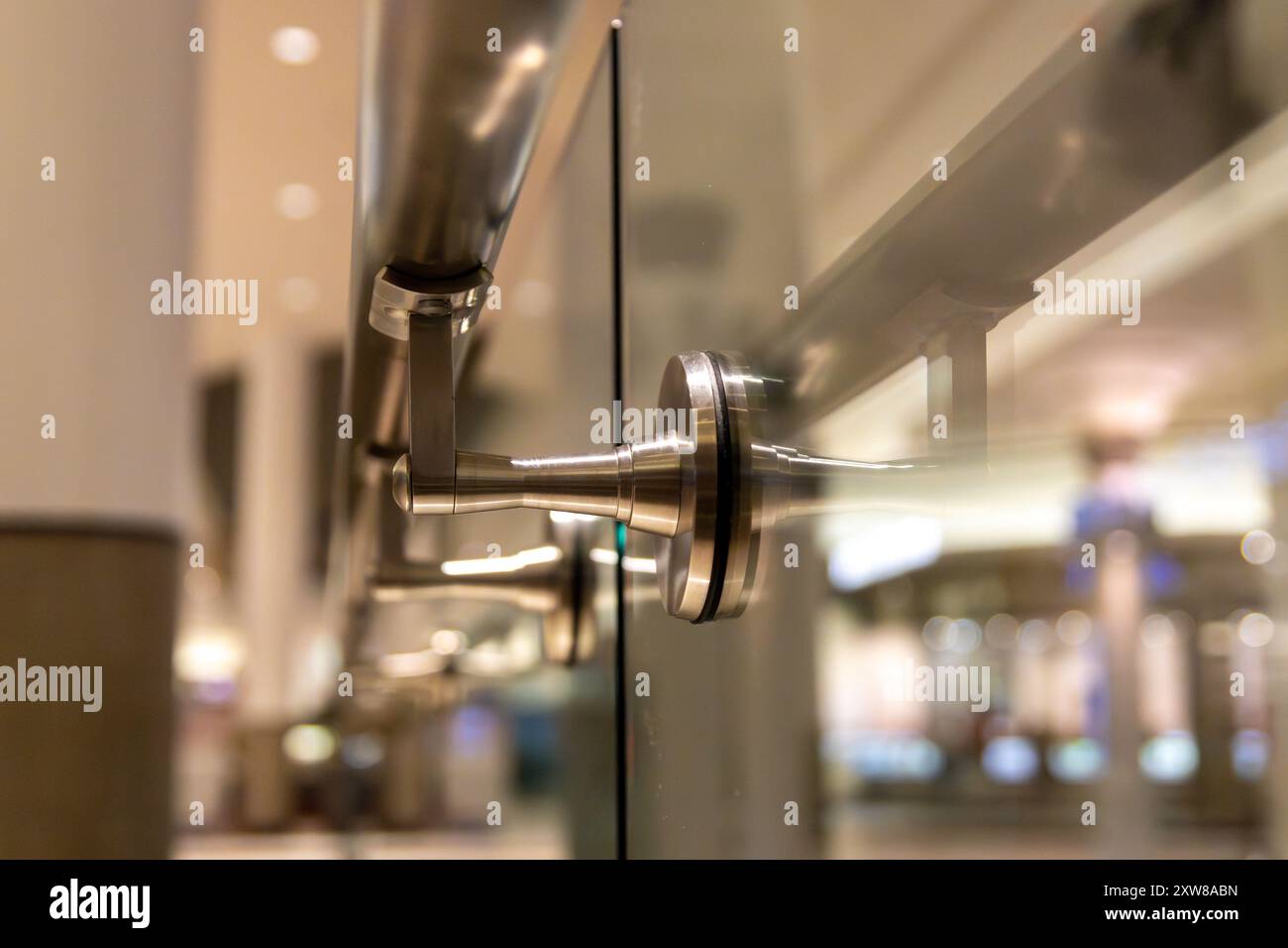 Primo piano di una moderna porta in vetro con finiture in acciaio inossidabile in un ambiente commerciale. Presa a Toronto, Canada. Foto Stock