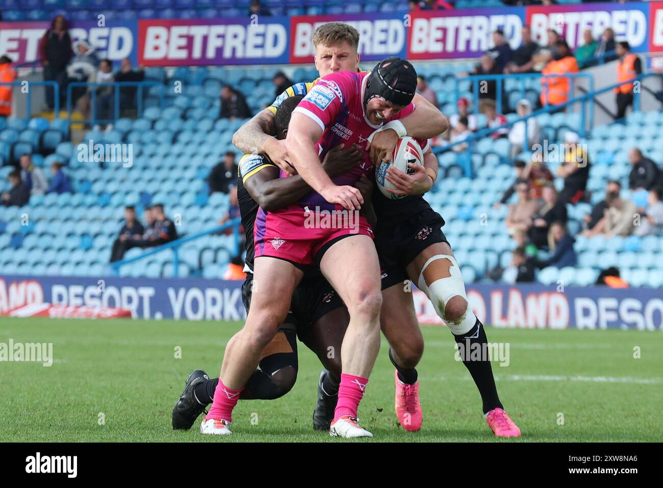 Leeds, Regno Unito. 18 agosto 2024. Elland Road, Leeds, West Yorkshire, 18 agosto 2024. Betfred Super League - Magic Weekend Huddersfield Giants vs Castleford Tigers Chris Hill di Huddersfield Giants è placcato da Alex Mellor e Muizz Mustapha di Castleford Tigers Credit: Touchlinepics/Alamy Live News Foto Stock