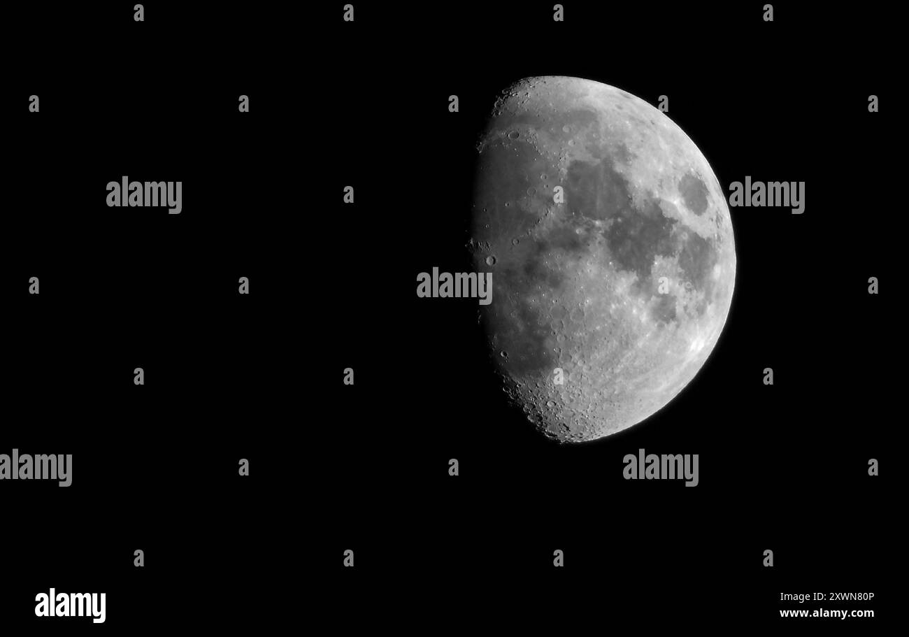 Mezzaluna cerata Half Moon. Dettagli della superficie lunare con spazio di copia. Satellite naturale della Terra nel cielo notturno. Concetto di astronomia Foto Stock