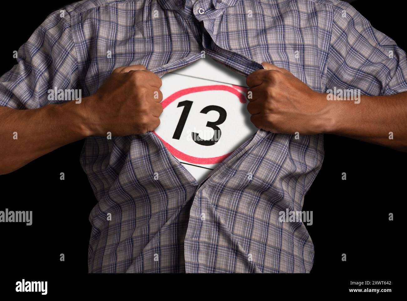 L'uomo si strappa la camicia, mostrando un segno con il numero 13, simboleggiando la superstizione e la paura interiore Foto Stock