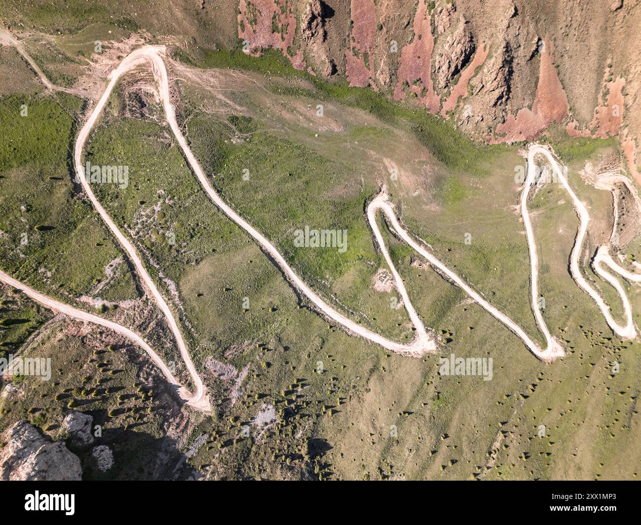 Vista aerea di una tortuosa strada di montagna, passo Kalmak Ashuu, attraverso la lussureggiante vegetazione del Kirghizistan, Asia centrale, Asia Foto Stock