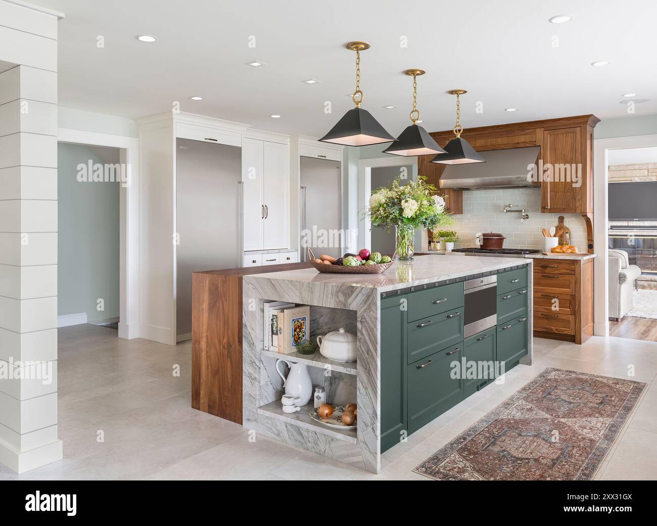 Cucina con armadi in noce, blu e bianco, frigorifero a colonna Sub-Zero e congelatore Foto Stock