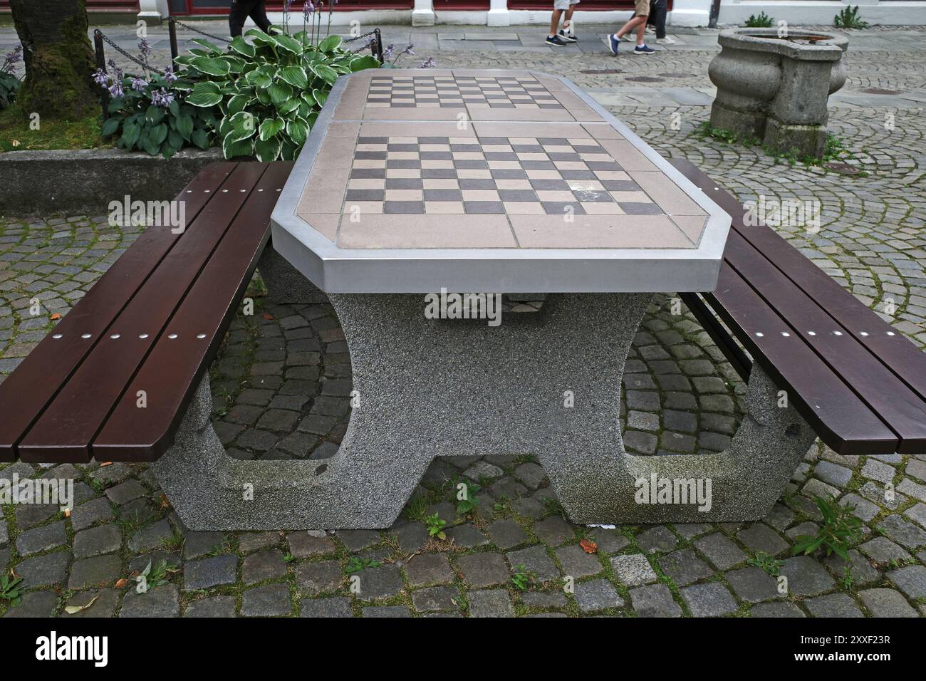 Un tavolo pubblico e panchine con due scacchiere. Foto Stock