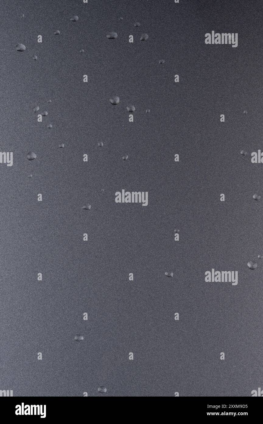 Gocce d'acqua su fondo grigio lucido in metallo Foto Stock