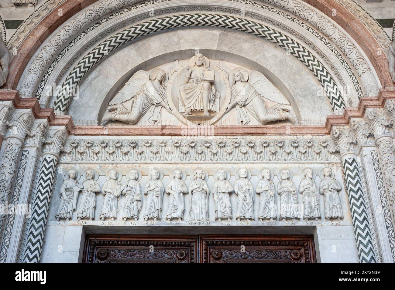 Splendida arte medievale sopra la porta della cattedrale di Lucca in Toscana, Italia. Foto Stock