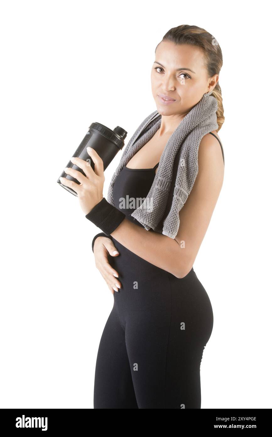 Donna in appoggio con un asciugamano attorno al collo dopo un allenamento fitness, isolato in bianco Foto Stock