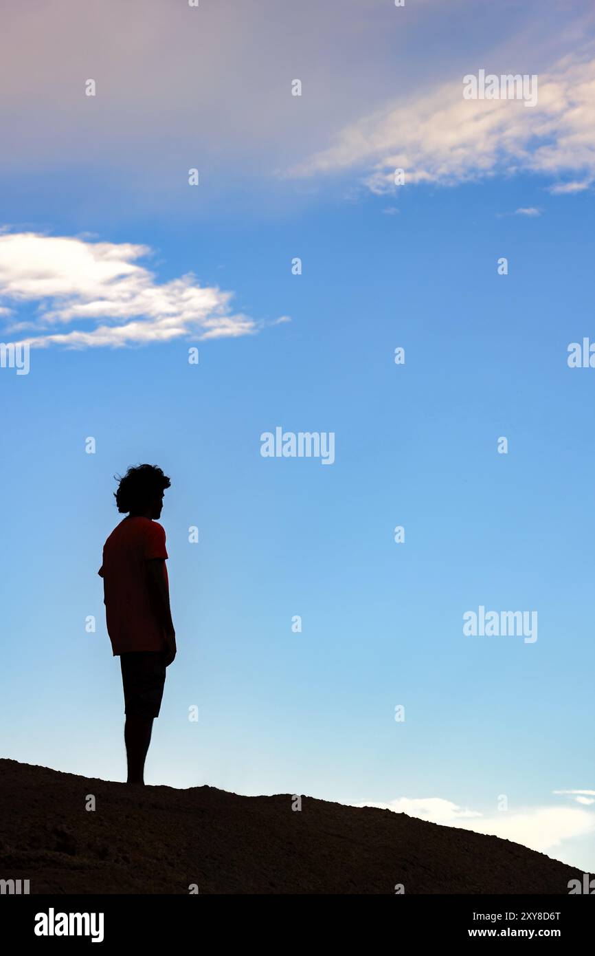 L'uomo oltre la pietra durante il tramonto Foto Stock