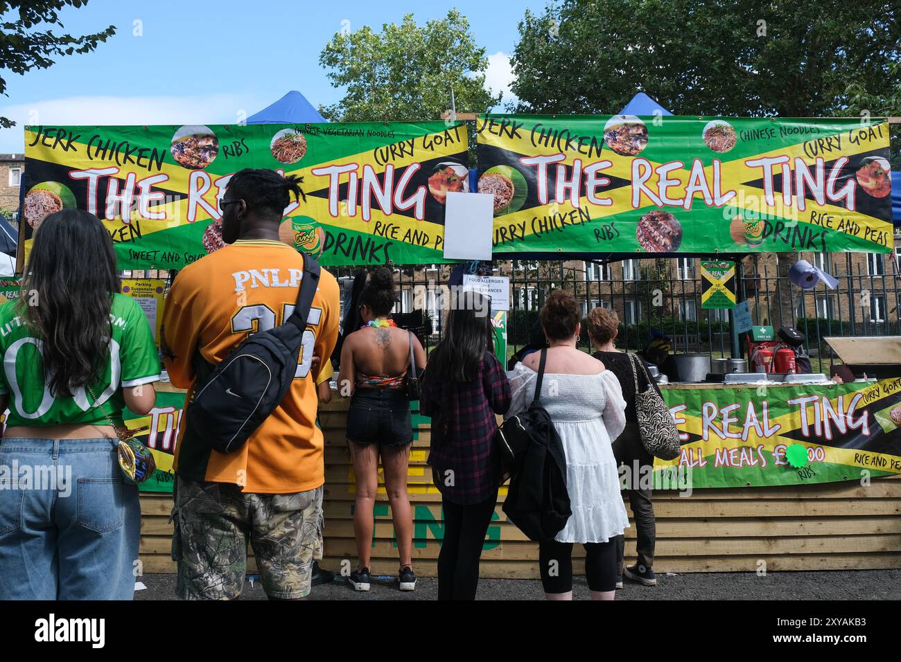 Londra, Regno Unito. Le bancarelle fiancheggiano il percorso del Carnevale di Notting Hill, che offre un'appetitosa scorta di pollo strapazzato, acqua di cocco, punch al rum e molto altro. Foto Stock