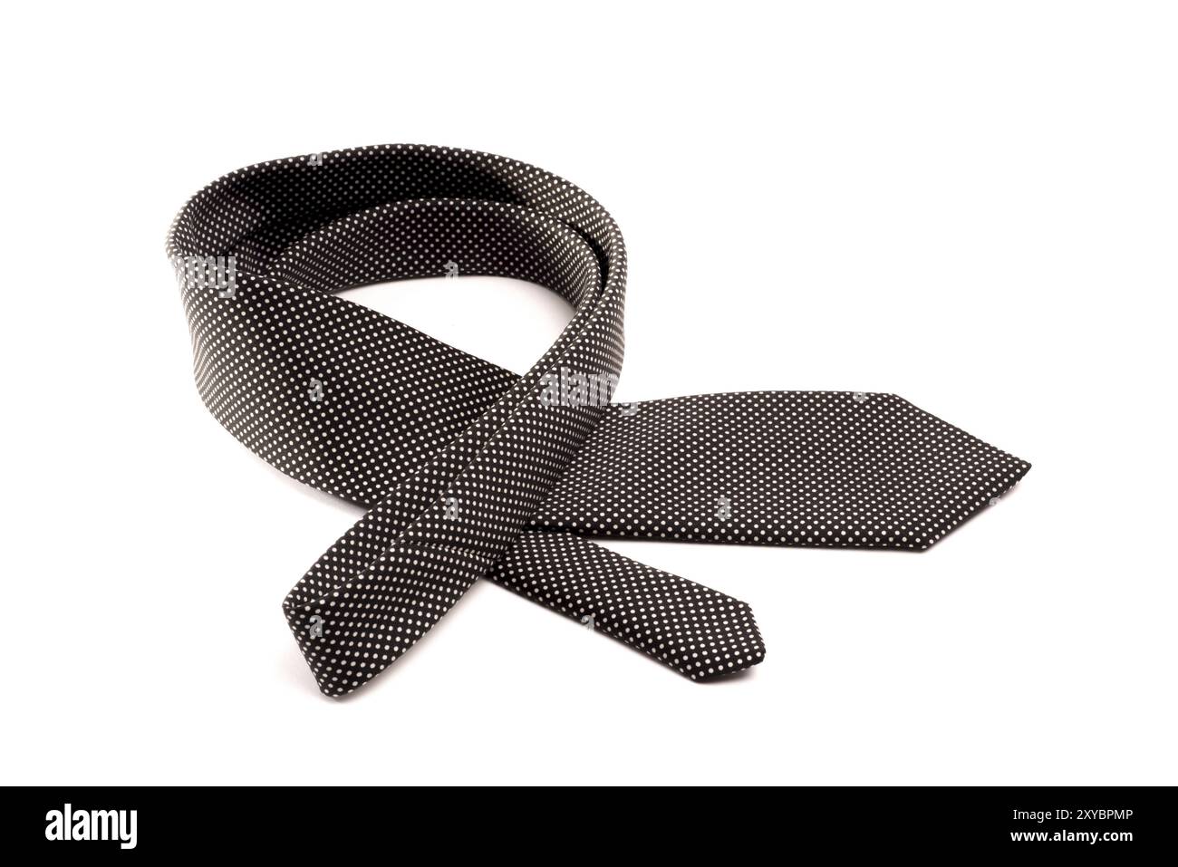 Una cravatta nera ripiegata con piccoli punti bianchi si trova in una curva su uno sfondo bianco isolato Foto Stock Una cravatta nera ripiegata con piccoli punti bianchi si trova in una curva su uno sfondo bianco isolato Foto Stock