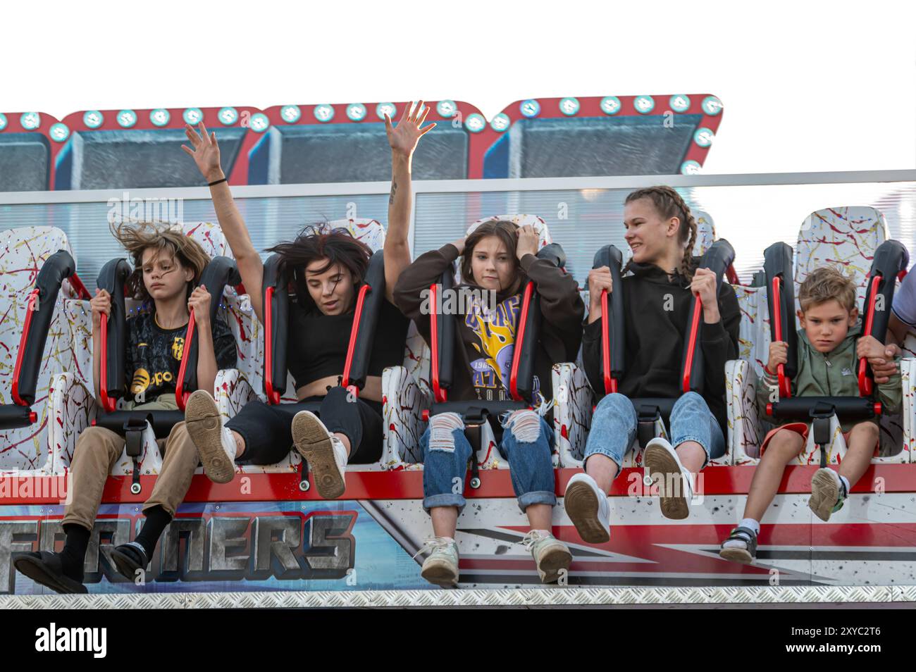 Engure, Lettonia, 8 luglio 2023: Giovani amanti del brivido si preparano per un divertente giro nel parco divertimenti durante un pomeriggio di sole Foto Stock