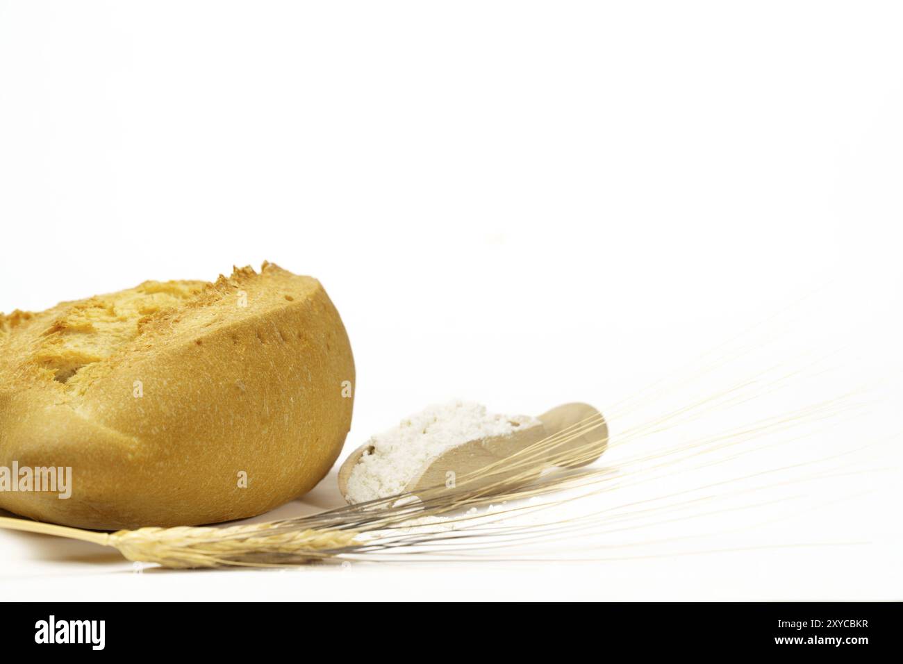 Pane soffice con farina, orecchie di grano e un mattarello isolato su sfondo bianco e spazio di copia Foto Stock