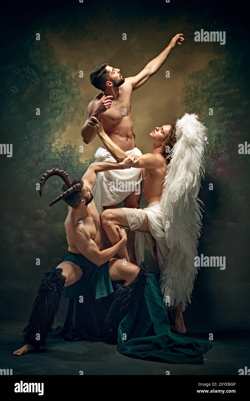 L'uomo muscolare raggiunge il cielo, sostenuto sia dall'angelo che dal demone, suggerendo un conflitto tra forze divine e terrene. Foto Stock