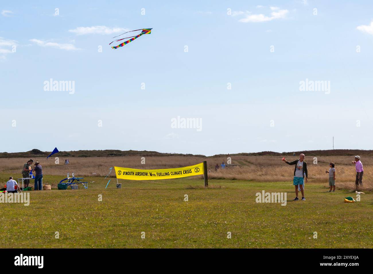 Hengistbury Head, Dorset, Regno Unito. 29 agosto 2024. Extinction Rebellion BCP protesta contro il Bournemouth Air Festival per celebrare l'evento amore non guerra con gli aquiloni della pace, facendo volare un aquilone come simbolo di pace. Affermano che il festival aereo ha un impatto negativo sull'ambiente, con tonnellate di CO2 rilasciate nell'atmosfera per ragioni completamente frivoli e molti degli aerei che volano sono macchine della morte costruite per la guerra, utilizzate nei conflitti globali. Anche il rumore degli aerei che volano può scatenare per coloro che sono fuggiti dai recenti conflitti per chiedere asilo. Crediti: Carolyn Jenkins/Alamy Live News Foto Stock