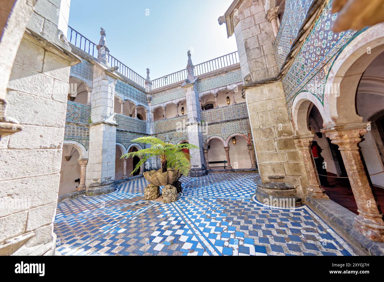 Palazzo pena Manueline Chiostro Sintra Portogallo // SINTRA, Portogallo — il Chiostro Manueline a Palácio pena, originariamente costruito nel 1511, presenta due piani con pareti adornate con piastrelle ispano-moresche del XVI secolo. Durante la conversione del monastero in un palazzo reale, gli archi del chiostro furono chiusi con finestre, che furono poi rimosse negli anni '1930 Le gallerie del chiostro, un tempo parte del monastero di Hieronymite, ora fungono da corridoi che collegano diverse sezioni del palazzo. Lo stile architettonico rappresenta il periodo manuelino portoghese, caratterizzato da ornati Foto Stock