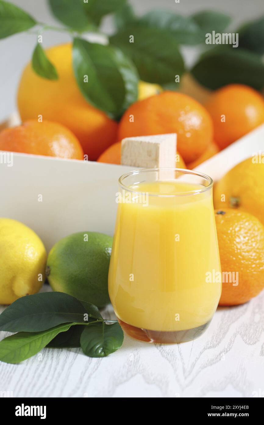 Agrumi freschi nella scatola di legno e succhi di frutta Foto Stock