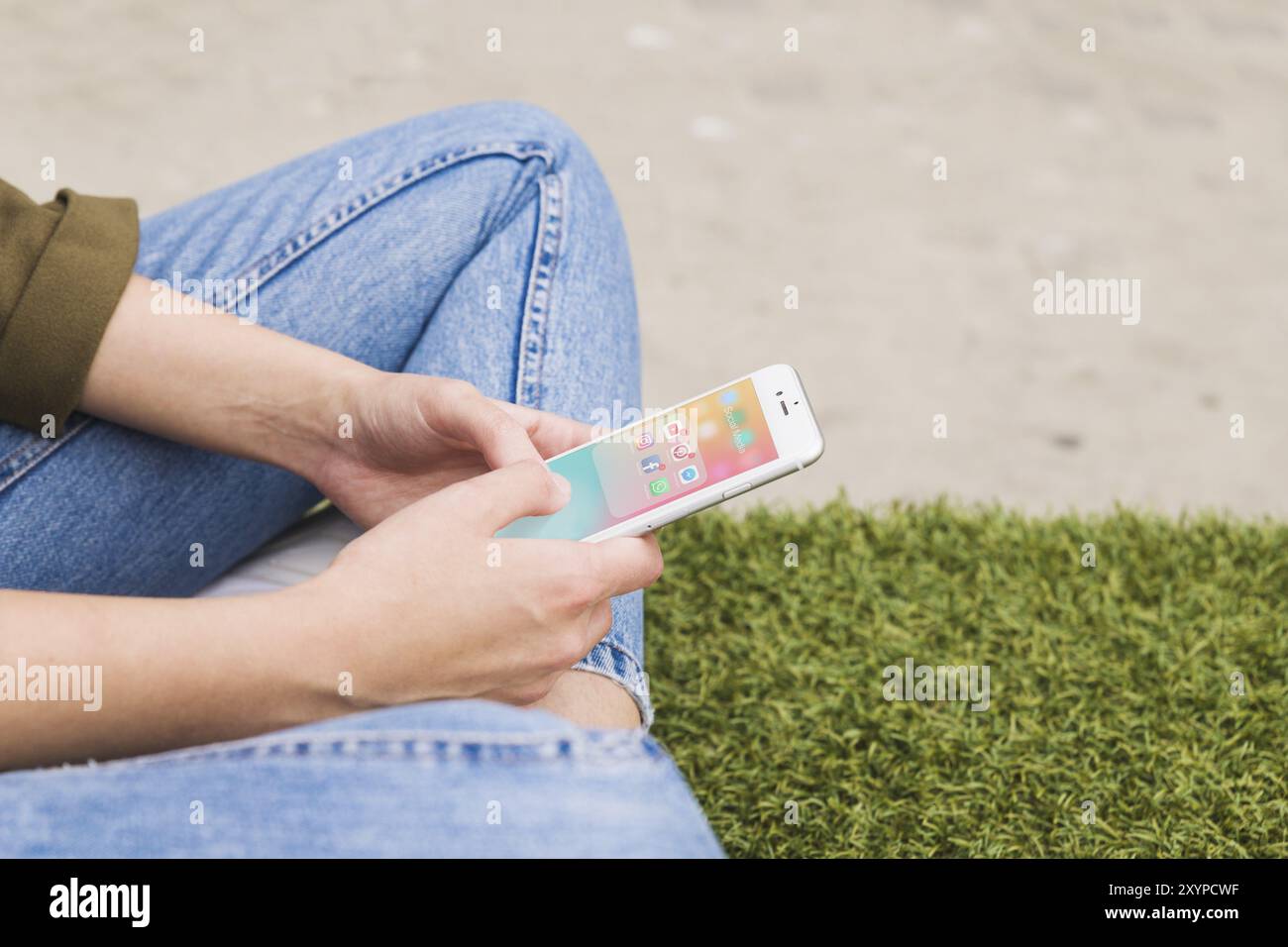 Mano di una donna che tiene il cellulare utilizzando un'applicazione di social media Foto Stock