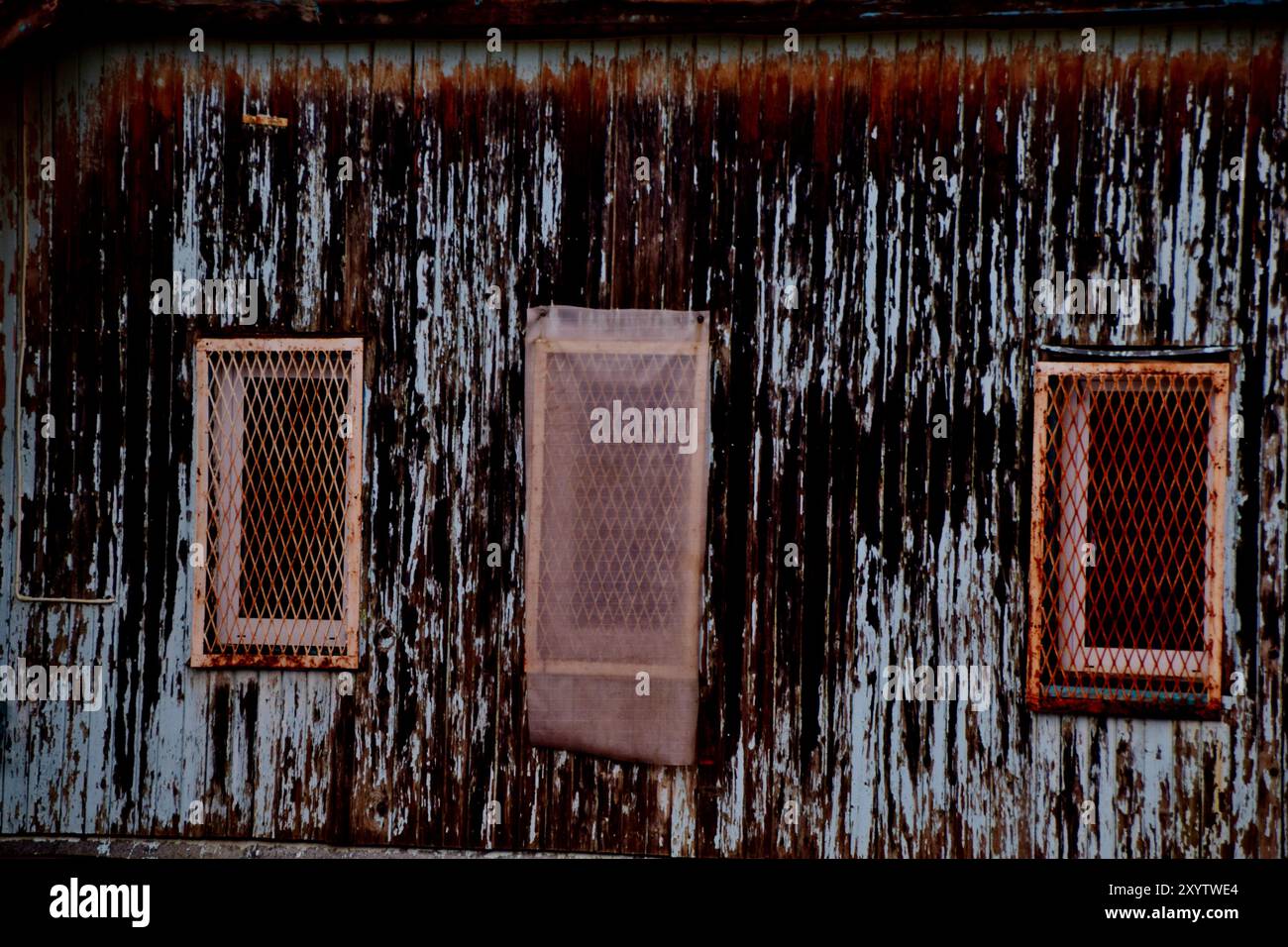 Vecchio muro del magazzino con finestre arrugginite Foto Stock