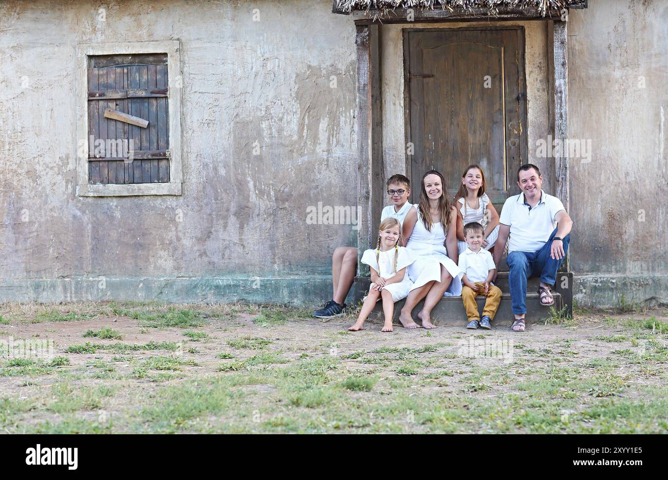 La famiglia felice con cinque bambini all'aperto vicino casa Foto Stock