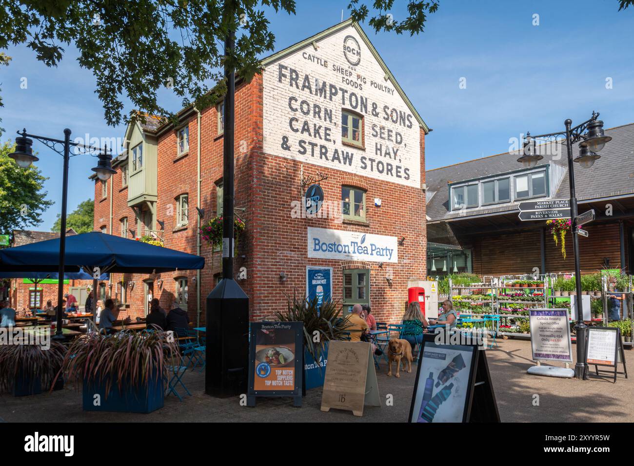 Persone sedute a bere qualcosa nel cortile del Furlong Shopping Centre fuori dalla caffetteria Boston Tea Party a Ringwood, Hampshire, Inghilterra, Regno Unito Foto Stock