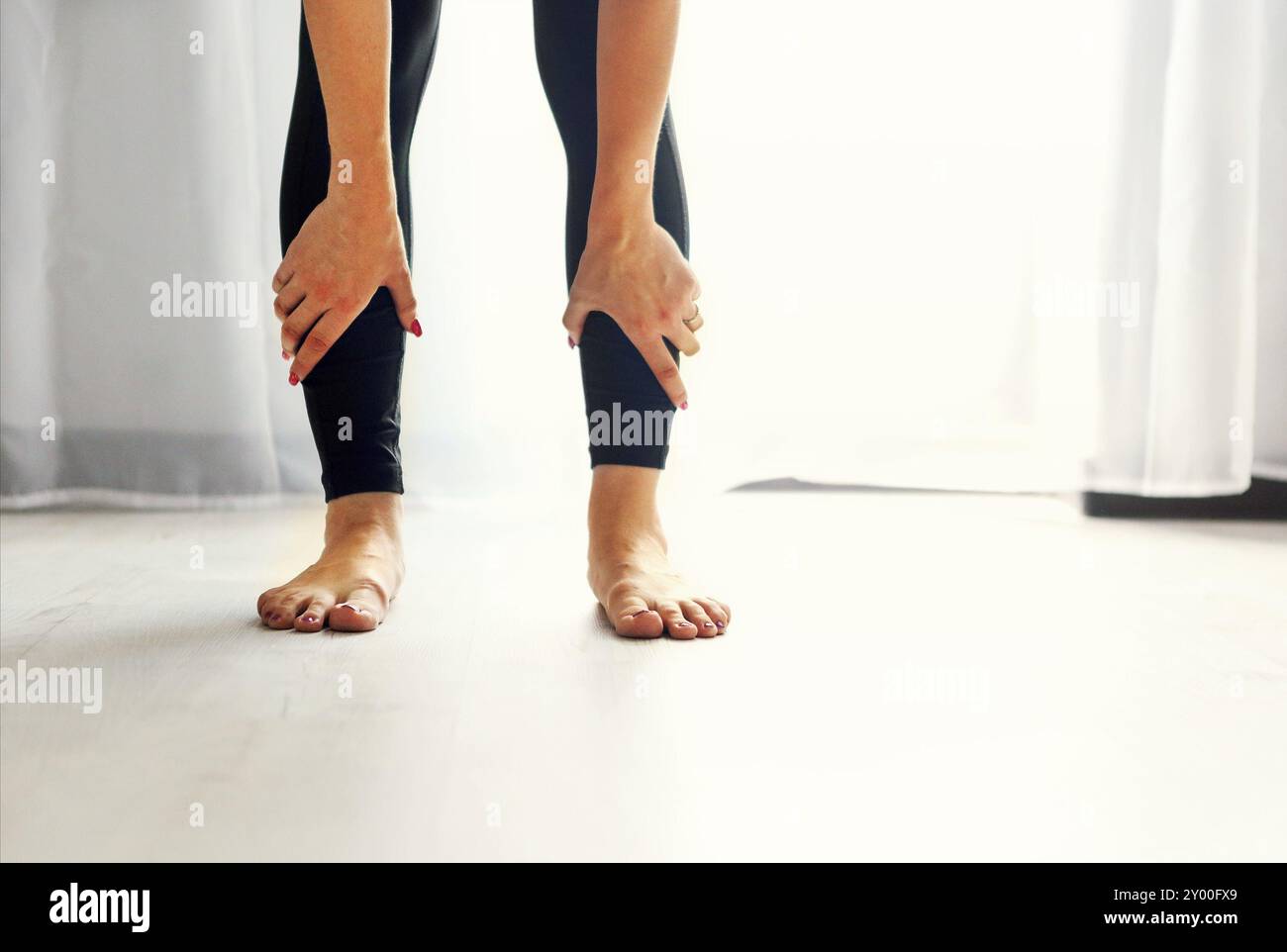 Stendi la. Giovane donna facendo esercizi di stretching per le gambe Foto Stock