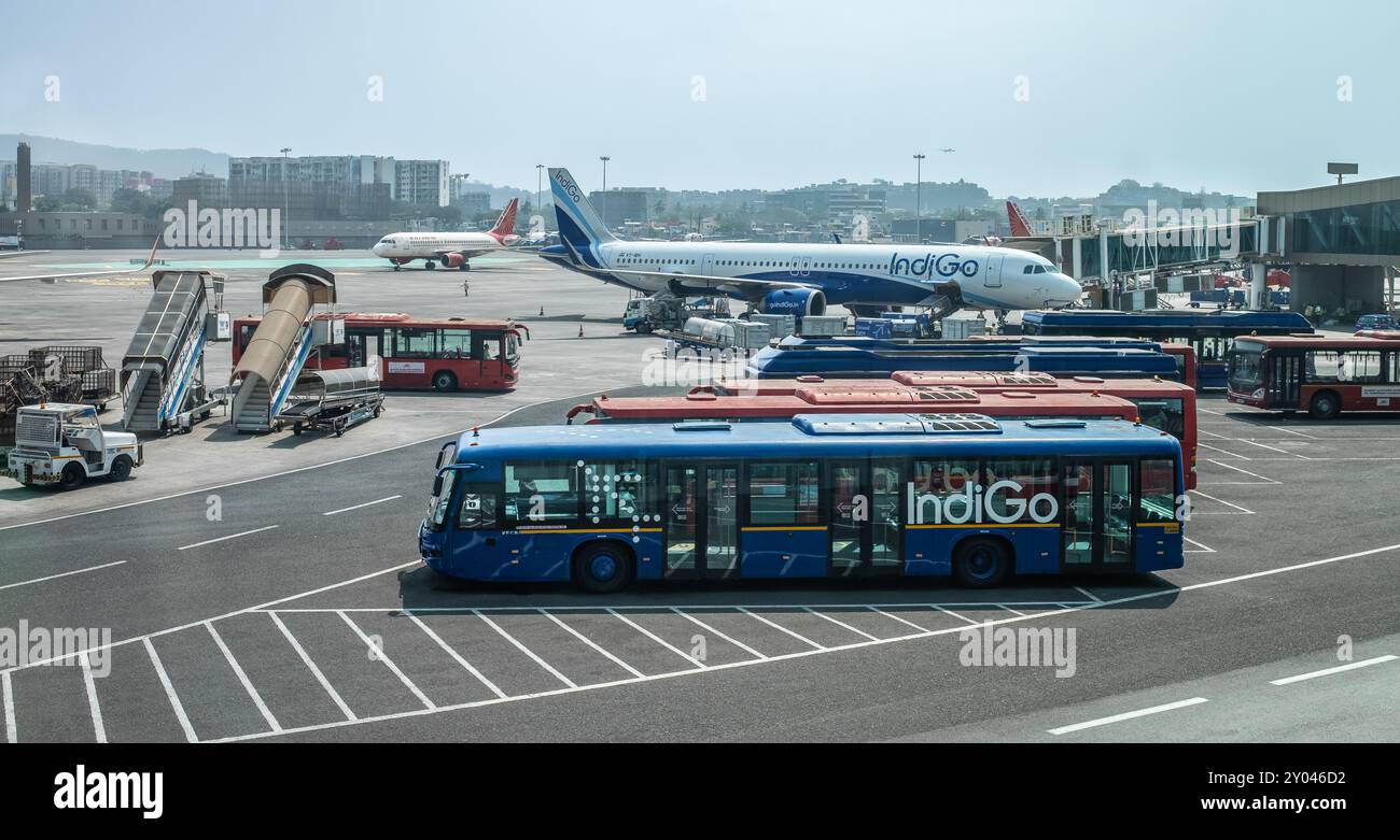 Aereo delle compagnie aeree Indigo e autobus passeggeri di Indigo Airlines presso l'aeroporto internazionale di Mumbai. L'aereo Indigo parcheggiato all'aeroporto. Foto di viaggio, edito Foto Stock