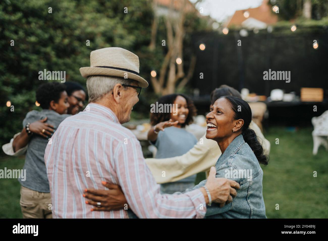 Allegri familiari maschili e femminili si divertono durante la riunione sociale alla festa in giardino Foto Stock