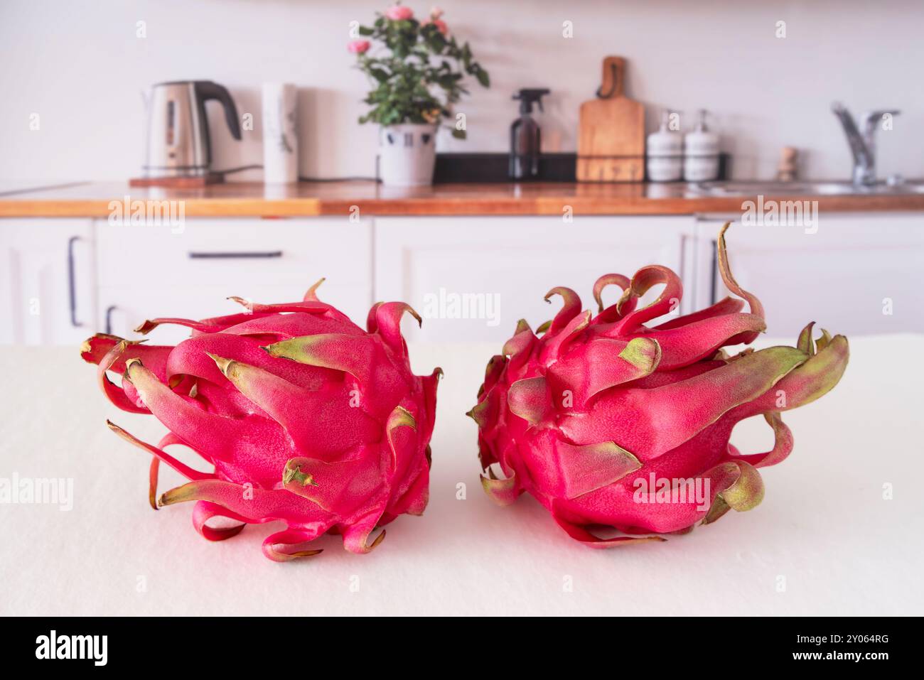 Primo piano della frutta del drago rosso tagliata su un tavolo da cucina Foto Stock