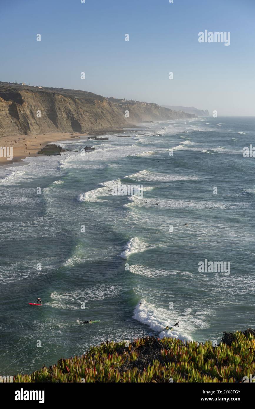 Spiaggia di Magoito con surfisti che navigano sulle onde del mare a Sintra, Portogallo, Europa Foto Stock