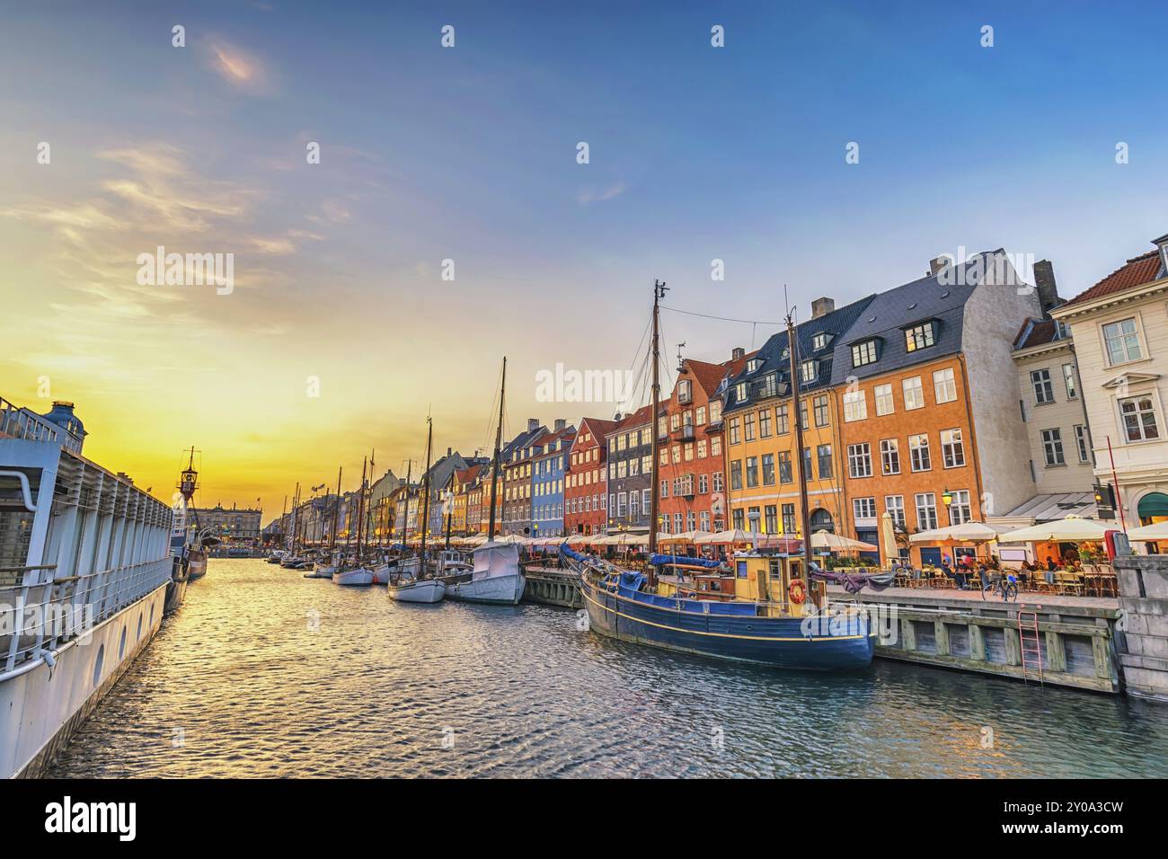 Copenhagen Danimarca, skyline della città al tramonto al porto di Nyhavn con una casa colorata Foto Stock